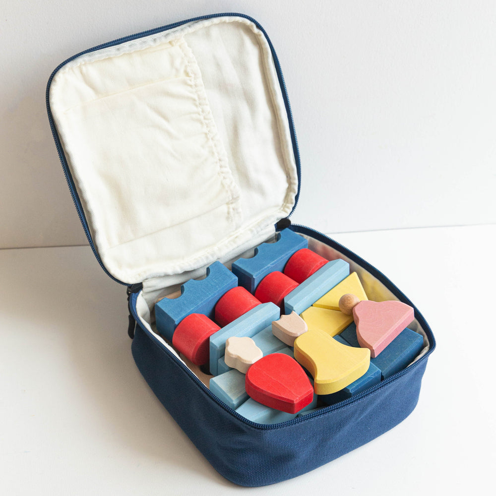 Colorful wooden blocks in a navy blue case on a white background