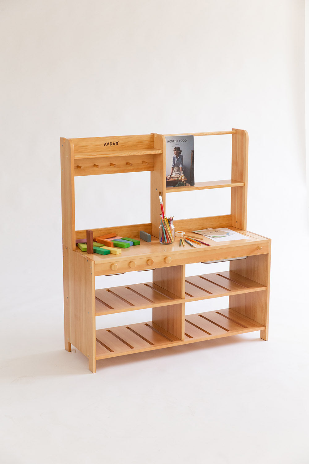 Wooden play kitchen with sinks and shelves, equipped with stainless steel cups and painters on the light background