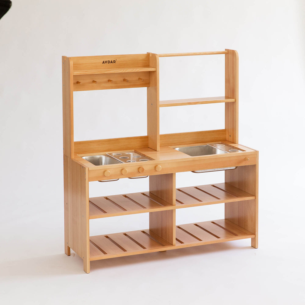 Wooden play kitchen with sinks and shelves, equipped with stainless steel trays and cups.