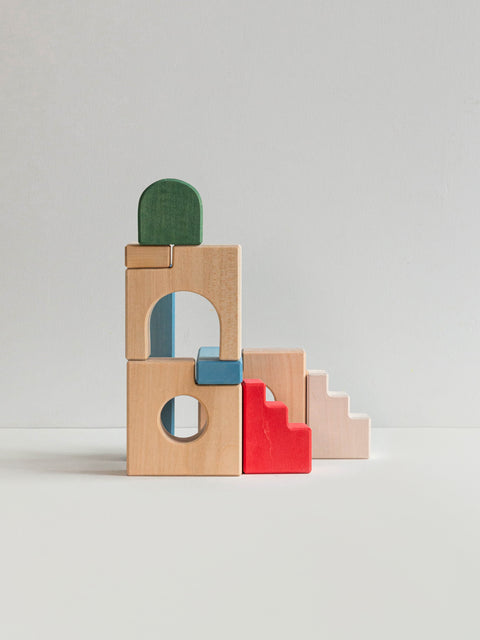 Colorful wooden building blocks and staircase blocks on a light gray background