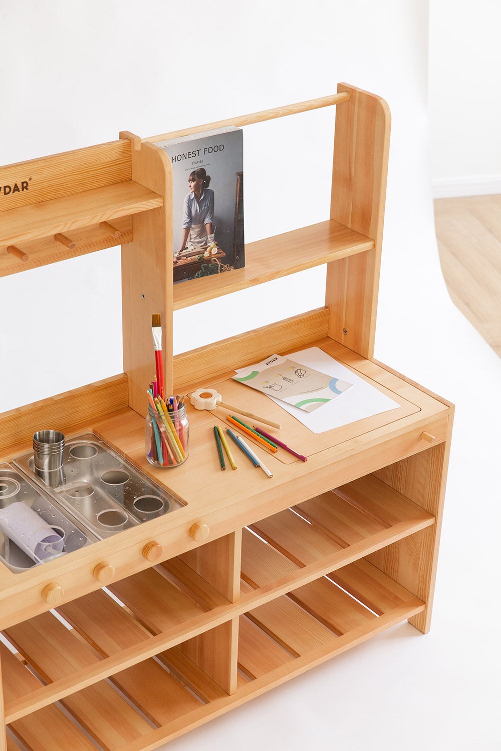 Wooden play kitchen with sinks and shelves, equipped with stainless steel cups and painters