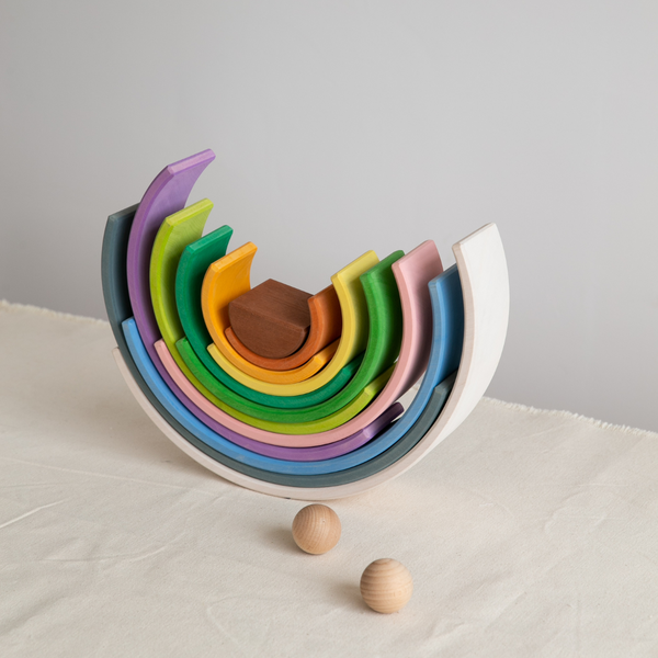 Four Seasons Rainbow Stacker with colorful nested wooden arches and two wooden balls