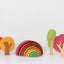 Wooden toys featured in yellow, red, green and brown trees, and rainbow on the white  background 