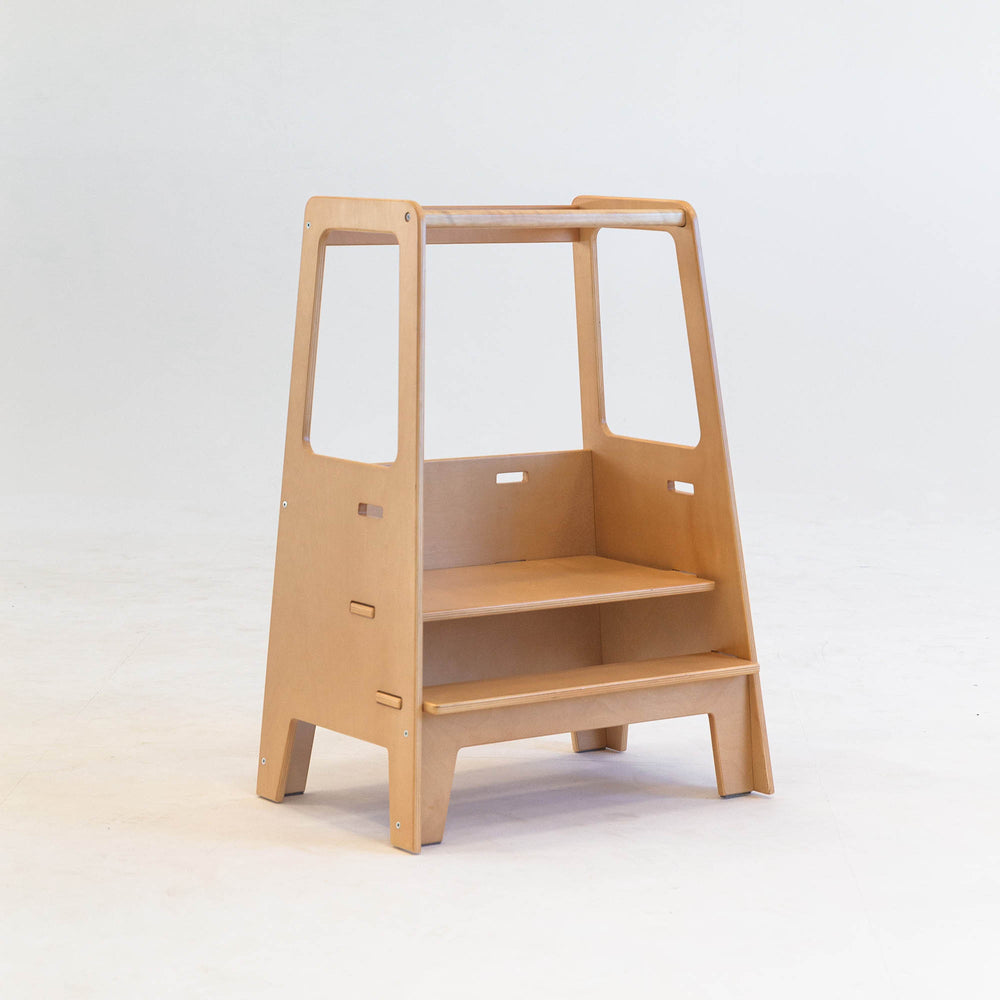 A beige wooden toddler tower with two platforms, designed for dual stability and adjustable heights.