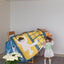 A girl opens posters of the tent with illustrations of a child and text on a white background.