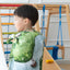 Child wearing the Kingdom Valley play cloth as a cape during imaginative play