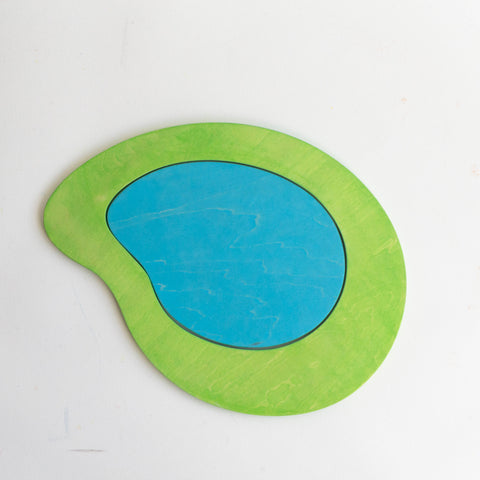 A stylized representation of a lake with a bright blue central area resembling water, surrounded by a green area simulating landmass.
