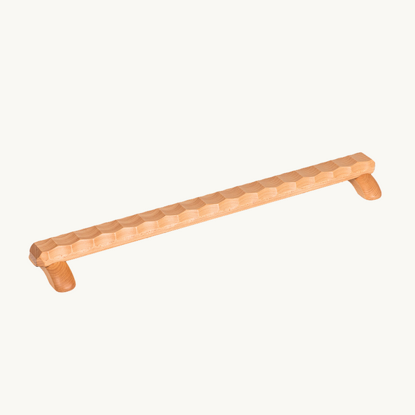 Naguri Balance Beam with a textured natural wood walkway and two rounded supports