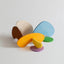 A collection of abstract shaped wooden blocks in various colors arranged on a white surface.