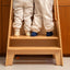 The two kids stand firmly on the top step of the wooden ladder