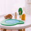 Wooden car,human, tree and house are on a small white coffee table 